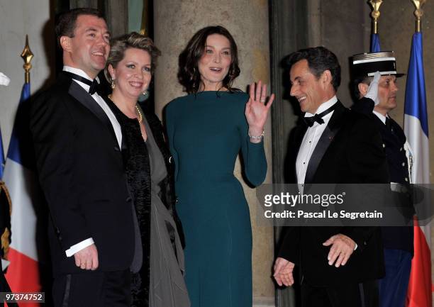 Russian President Dmitry Medvedev and his wife Svetlana Medvedeva arrive to attend a state dinner in their honour, hosted by French President Nicolas...