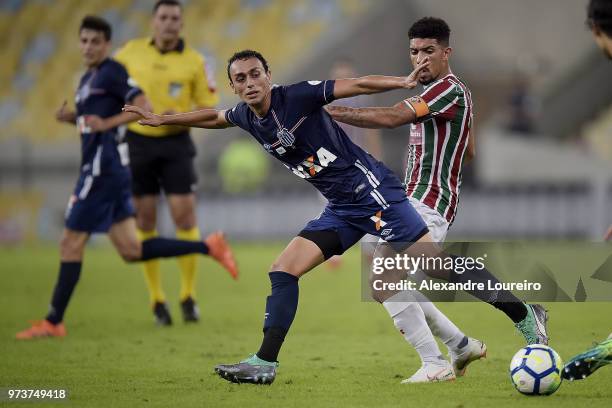 Douglas of Fluminense struggles for the ball with Diego Pituca of Santos during the match between Fluminense and Santos as part of Brasileirao Series...