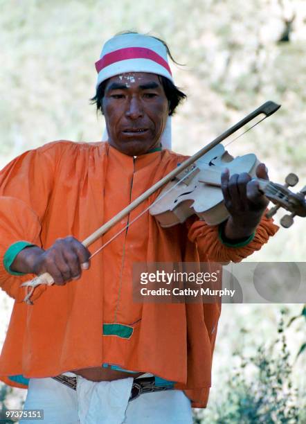 Tarahumara musician plays a stringed instrument, Copper Canyon, Mexico, 1998.