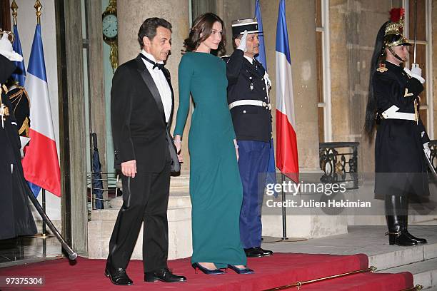 French President Nicolas Sarkozy and his wife Carla Bruni-Sarkozy walk to greet their guests Russian President Dmitry Medvedev and his wife Svetlana...