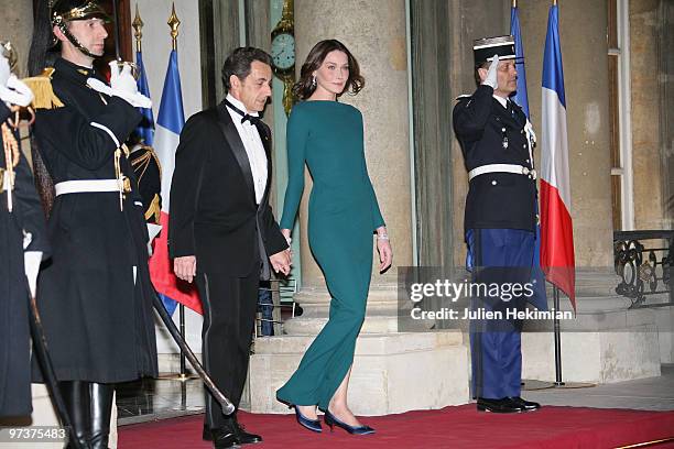 French President Nicolas Sarkozy and his wife Carla Bruni-Sarkozy walk to greet their guests Russian President Dmitry Medvedev and his wife Svetlana...