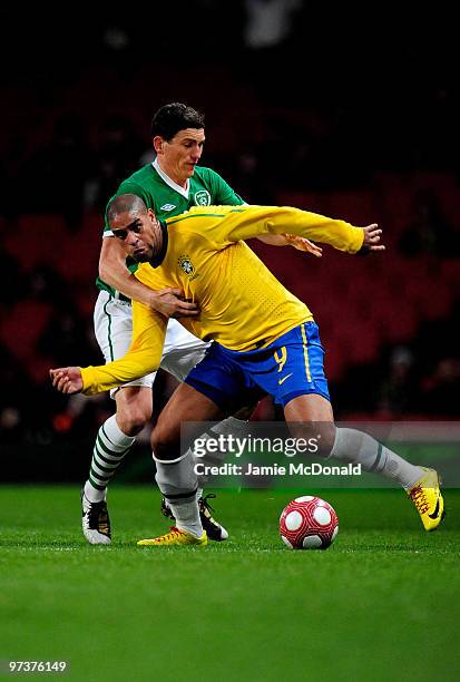 Paul McShane of Ireland battles with Adriano of Brasil during the International Friendly match between Republic of Ireland and Brazil played at...