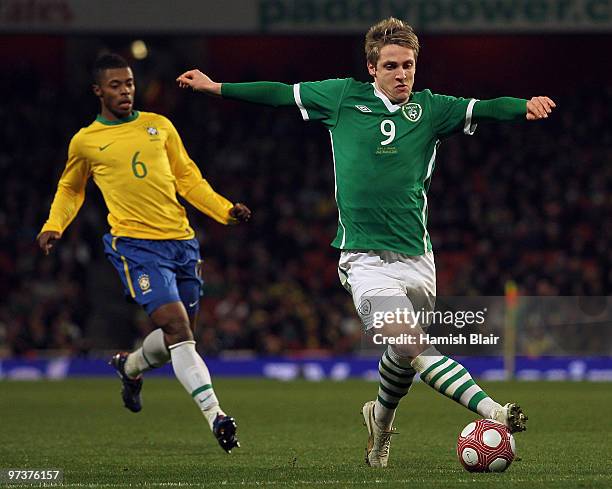 Kevin Doyle of Ireland reaches for the ball in front of Michel Bastos of Brazil during the International Friendly match between Republic of Ireland...