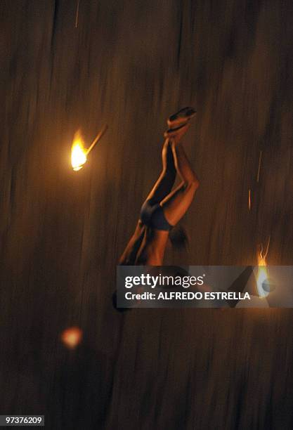 Cliff diver jumps with torches from 'La Quebrada' cliff in Acapulco, Mexico, on March 1, 2010. The tradition of 'La Quebrada' goes back to 1934, when...
