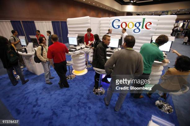 Attendees check out the Google booth at the Search Marketing Expo West conference in Santa Clara, California, U.S., on Tuesday, March 2, 2010. Google...