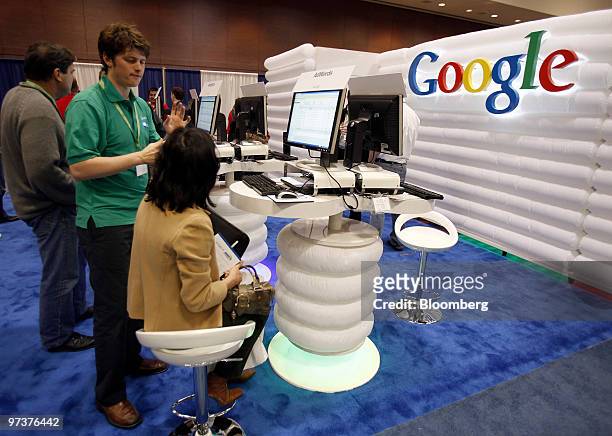 Attendees check out the Google booth at the Search Marketing Expo West conference in Santa Clara, California, U.S., on Tuesday, March 2, 2010. Google...