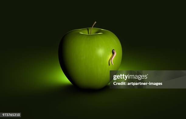a worm eats through an apple - wurm stock-fotos und bilder