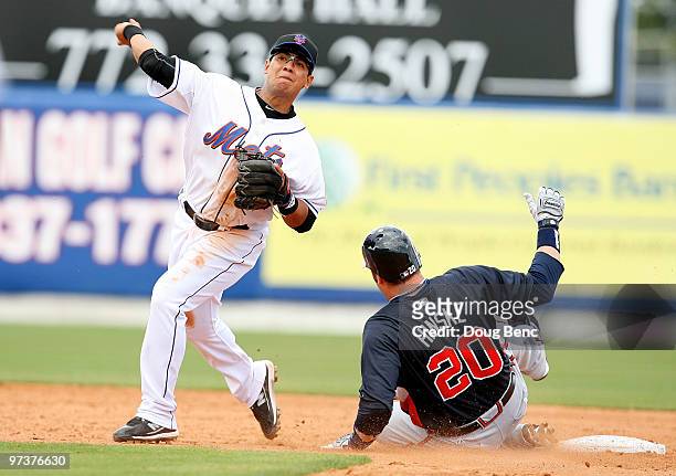 First baseman Eric Hinske of the Atlanta Braves breaks up a double-play attempt by second baseman Luis Hernandez of the New York Mets during a spring...