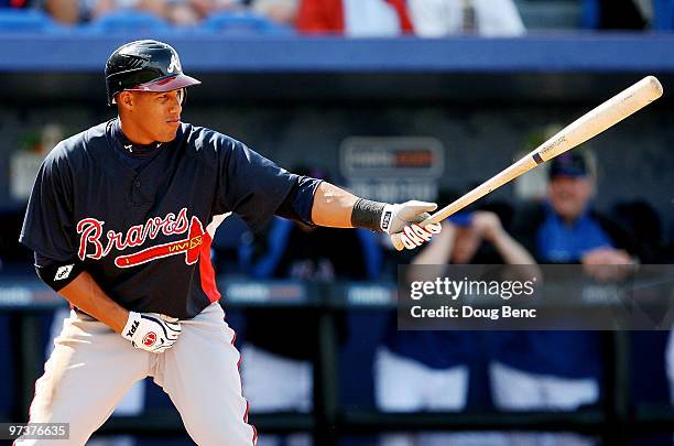 Shortstop Yunel Escobar of the Atlanta Braves waits for a pitch while taking on the New York Mets during a spring training game at Tradition Field on...