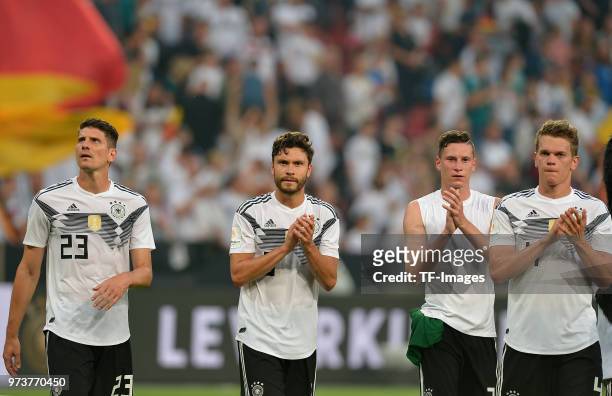Mario Gomez of Germany, Jonas Hector of Germany, Julian Draxler of Germany and Matthias Ginter of Germany gesture after the international friendly...