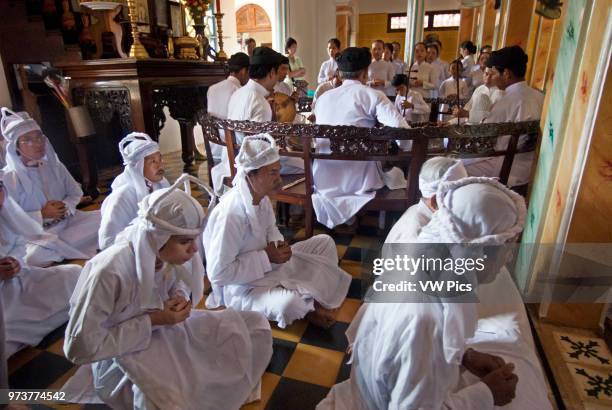 Worshipers at midday prayer in the Cao Dai temple, Tay Ninh, Vietnam, Asia.