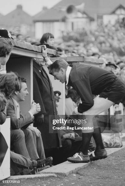 English former soccer player and manager of Brighton & Hove Albion FC Brian Clough being scolded by referee Tony Glasson during a match, UK, 21st...