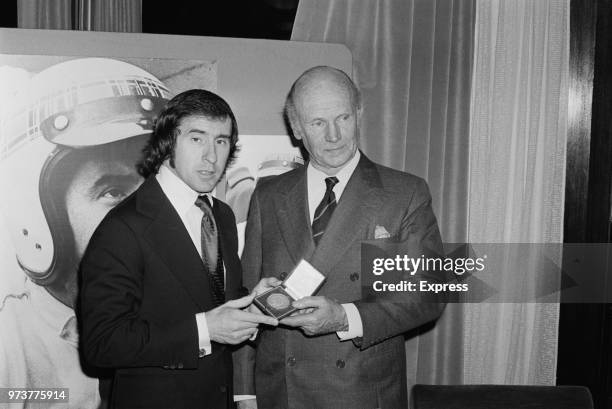 British Formula One racing driver Jackie Stewart awarded by Lord Howe with BARC gold metal for his outstanding career and 26 Grand Prix wins, UK,...