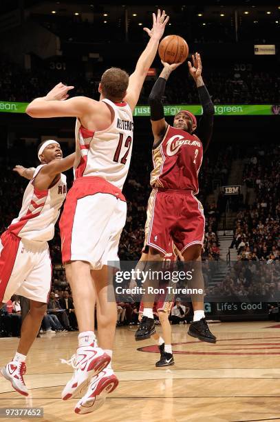 Mo Williams of the Cleveland Cavaliers shoots against Rasho Nesterovic of the Toronto Raptors during the game on February 26, 2010 at Air Canada...