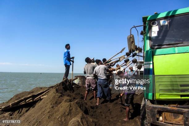 Construction workers shovel dirt in Bahir Dar, Ethiopia.