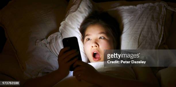 shock horror on mobile phone - cruel stock pictures, royalty-free photos & images