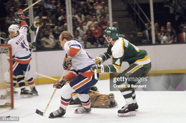 Bob Nystrom of the New York Islanders skates to the net under pressure from Craig Hartsburg of the Minnesota North Stars during the 1981 Stanley Cup...