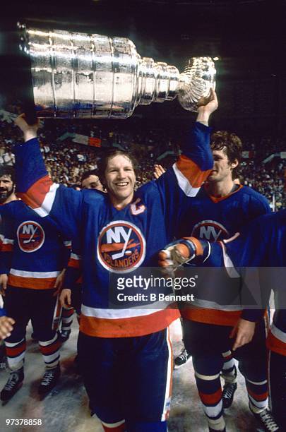 Captain Denis Potvin of the New York Islanders hoists the Stanley Cup after winning the 1982 Stanley Cup Finals against the Vancouver Canucks at the...