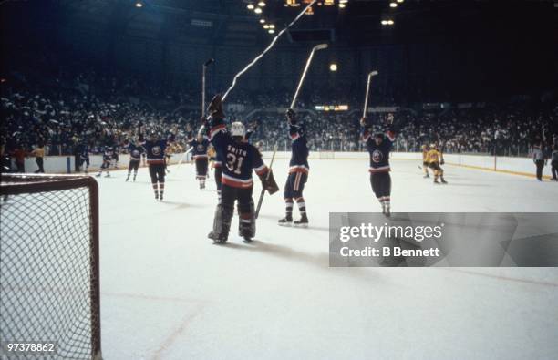 Goaltender Billy Smith of the New York Islanders raises his glove to celebrate after winning the 1982 Stanley Cup Finals against the Vancouver...