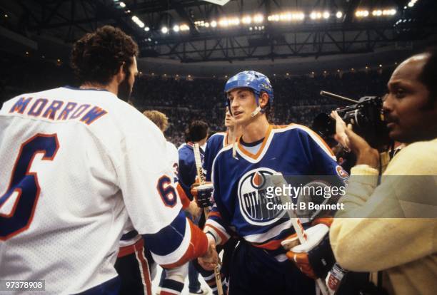 Wayne Gretzky of the Edmonton Oilers shakes hands with Ken Morrow of the New York Islanders after the Islanders defeated the Edmonton Oilers 4-2 in...