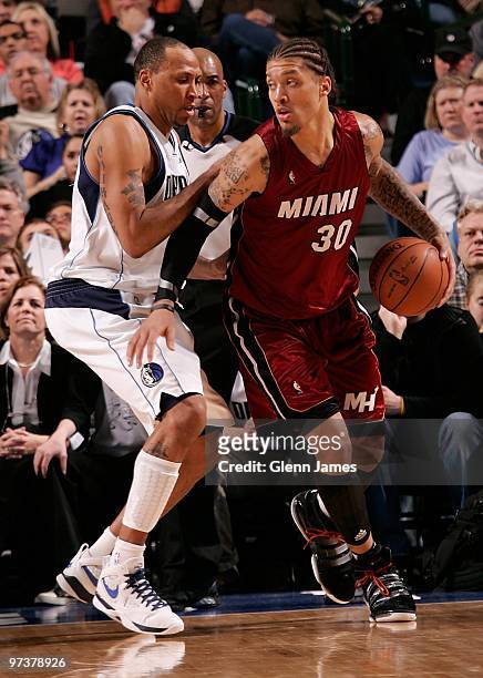 Michael Beasley of the Miami Heat moves the ball against Shawn Marion of the Dallas Mavericks during the game at the American Airlines Center on...