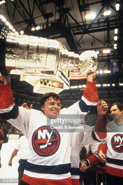 Anders Kallur of the New York Islanders hoists the Stanley Cup after the Islanders defeated the Edmonton Oilers 4-2 in Game Four of the 1983 Stanley...