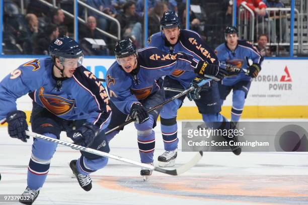 Tobias Enstrom and Bryan Little of the Atlanta Thrashers pursue the puck against the Florida Panthers at Philips Arena on March 2, 2010 in Atlanta,...