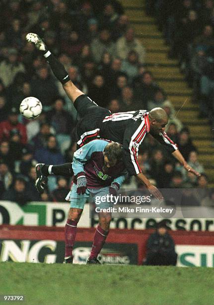 Brian Dean of Middlesbrough jumps over Paul Marson of Villa during the match between Aston Villa and Middlesbrough in the FA Carling Premiership at...