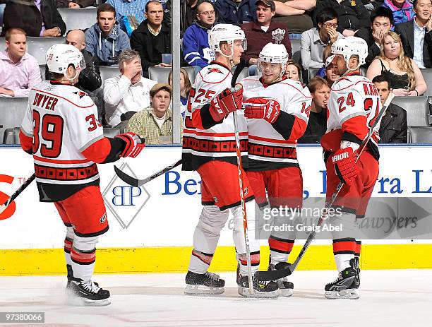 Patrick Dwyer, Joni Pitkanen, Sergei Samsonov and Scott Walker of the Carolina Hurricanes celebrate a third period goal during game action against...