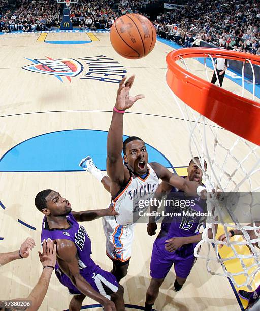 Jeff Green of the Oklahoma City Thunder goes to the basket against Tyreke Evans and Joey Dorsey of the Sacramento Kings on March 2, 2010 at the Ford...