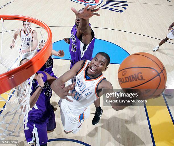 Kevin Durant of the Oklahoma City Thunder goes to the basket against Sean May of the Sacramento Kings on March 2, 2010 at the Ford Center in Oklahoma...