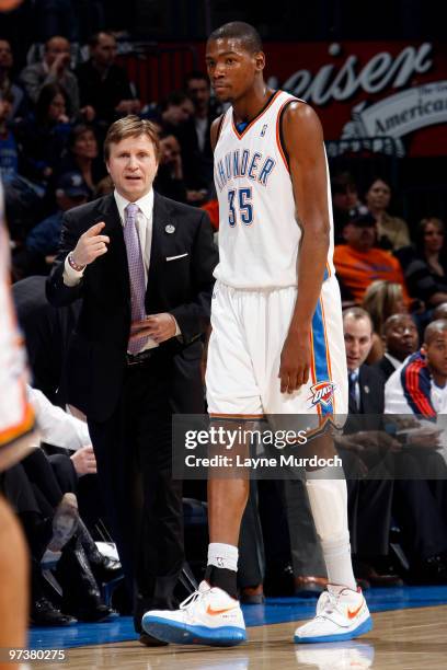 Scott Brooks, Head Coach of the Oklahoma City Thunder, speaks with Kevin Durant during the game against the Sacramento Kings on March 2, 2010 at the...