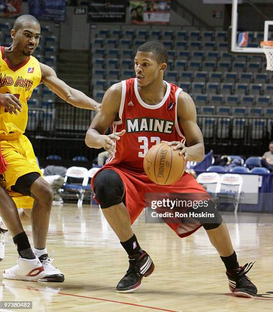 Morris Almond of the Maine Red Claws drives on Ron Howard of the Fort Wayne Mad Ants at Allen County Memorial Coliseum on March 2, 2010 in Fort...