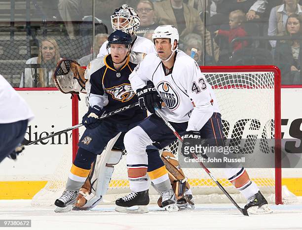 Patric Hornqvist of the Nashville Predators fights against Jason Strudwick of the Edmonton Oilers for position in front of goalie Jeff Deslauriers on...