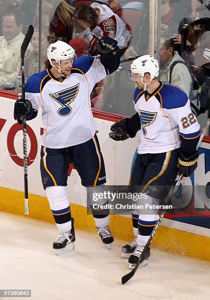 Jay McClement of the St. Louis Blues celebrates with teammate Brad Boyes after Boyes scored a second period goal against the Phoenix Coyotes during...