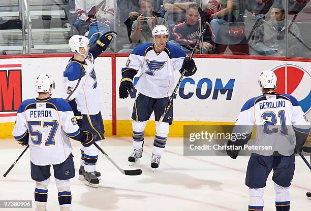 Andy McDonald of the St. Louis Blues celebrates with teammates David Perron, Barret Jackman and Patrik Berglund after McDonald scored a second period...