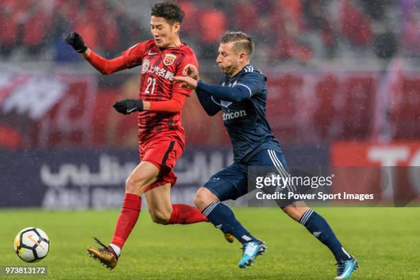 Melbourne Midfielder Kosta Barbarouses in action against Shanghai FC Midfielder Yu Hai during the AFC Champions League Group F match between Shanghai...