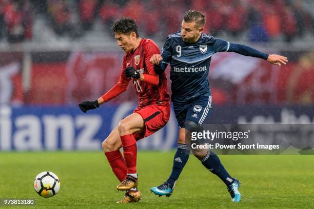 Melbourne Midfielder Kosta Barbarouses in action against Shanghai FC Midfielder Yu Hai during the AFC Champions League Group F match between Shanghai...