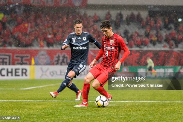 Shanghai FC Forward Oscar Emboaba Junior in action against Melbourne Defender James Donachie during the AFC Champions League Group F match between...