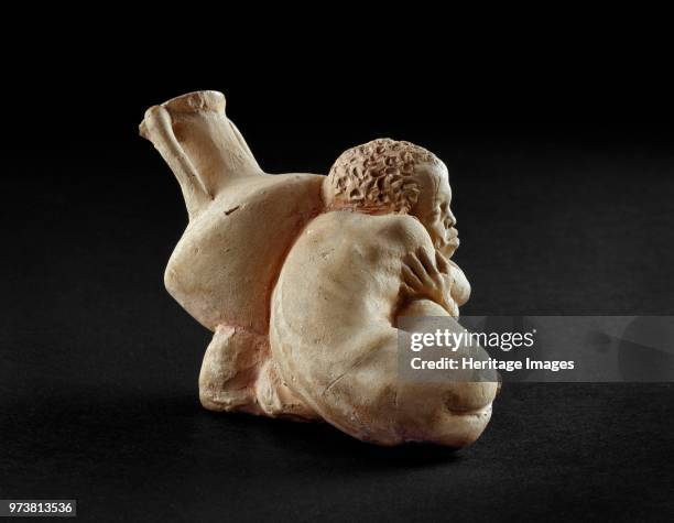 Terracotta figurine of an Afro-Hellenic boy, possibly a slave, asleep next to a Rhodian amphora, 4th century BC. Dimension: height: 6.3 cmArtist...