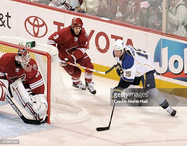 Brad Winchester of the St. Louis Blues moves the puck behind Ilya Bryzgalov of the Phoenix Coyotes as Keith Yandle chases him on March 2, 2010 at...