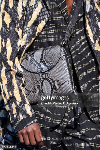 Model, bag detail, walks the runway at the Roberto Cavalli show during the 94th Pitti Immagine Uomo on June 13, 2018 in Florence, Italy.