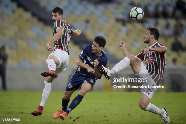 Roger IbaÃ±ez of Fluminense and Nathan Ribeiro struggles for the ball with LÃ©o Cittadini of Santos during the match between Fluminense and Santos as...