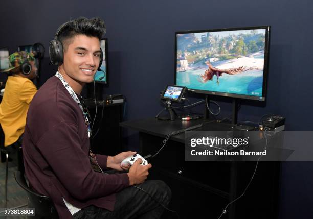 Siva Kaneswaran of The Wanted plays Assassin's Creed Odyssey during E3 2018 at Los Angeles Convention Center on June 13, 2018 in Los Angeles,...