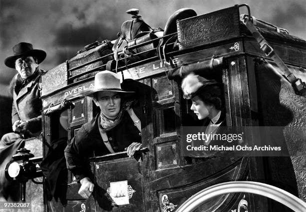 George Bancroft, John Wayne and Louise Platt on the set of the movie 'Stagecoach' in 1939.