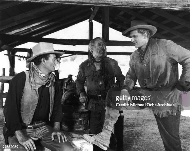John Wayne, Ward Bond and James Arness on the set of the movie 'Hondo' in 1953.