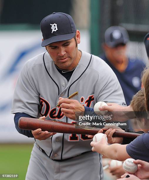 Johnny Damon of the Detroit Tigers signs autographs during the spring training game against Florida Southern College at Joker Marchant Stadium on...