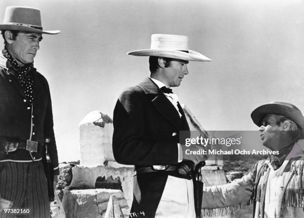 Ken Curtis, Laurence Harvey and Richard Widmark on the set of the movie 'The Alamo' in 1960 at the Alamo Village producer and star John Wayne built...