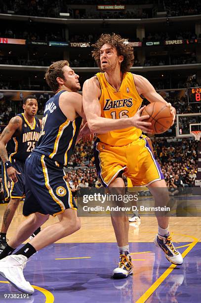 Pau Gasol of the Los Angeles Lakers makes a move in the paint against Josh McRoberts of the Indiana Pacers at Staples Center on March 2, 2010 in Los...