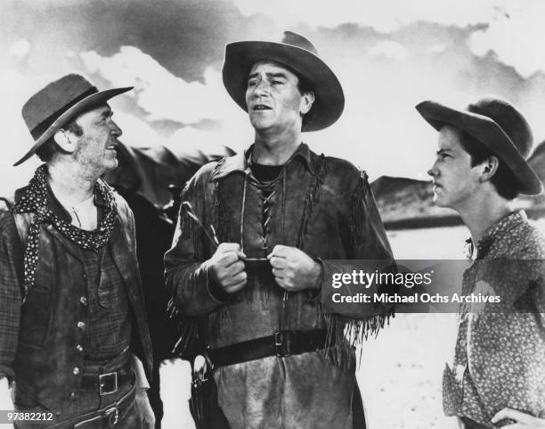 Walter Brennan, John Wayne and Mickey Kuhn on the set of the movie 'Red River' in 1948 in the Whetstone Mountains, Arizona.